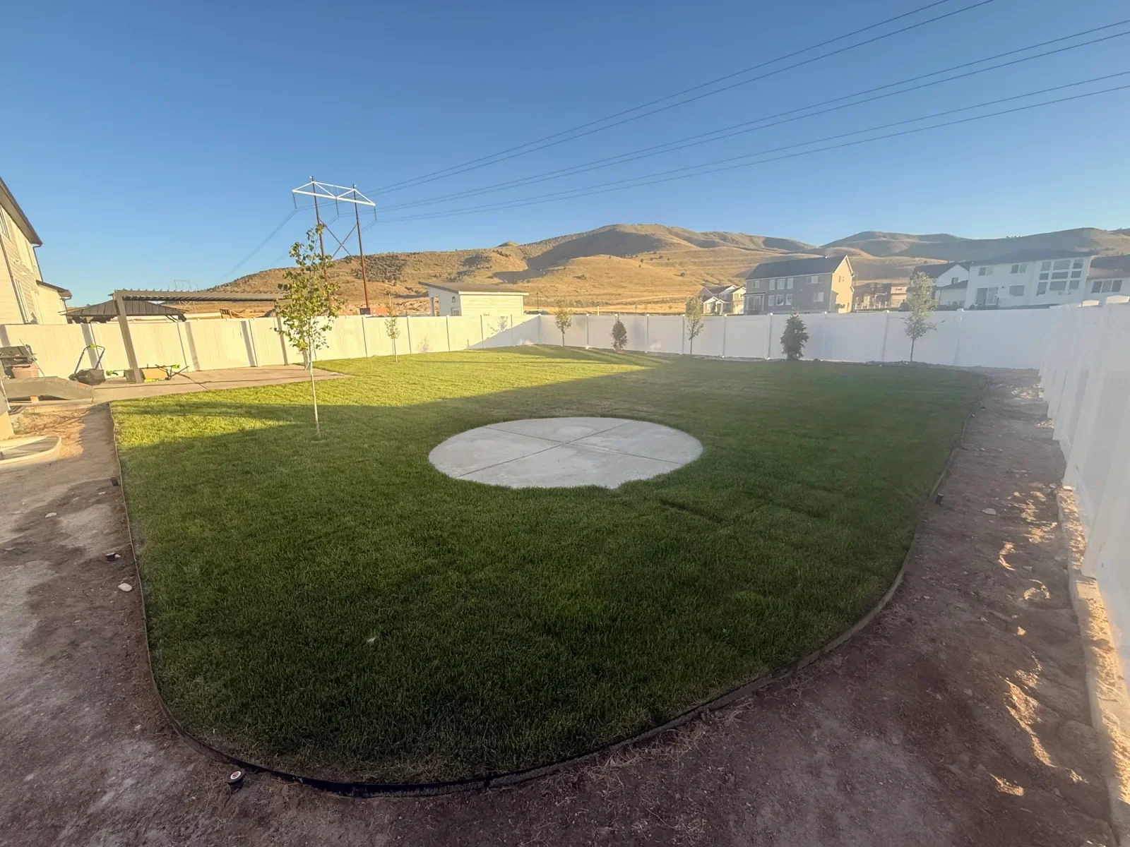 Freshly installed client lawn across a broad Utah backyard