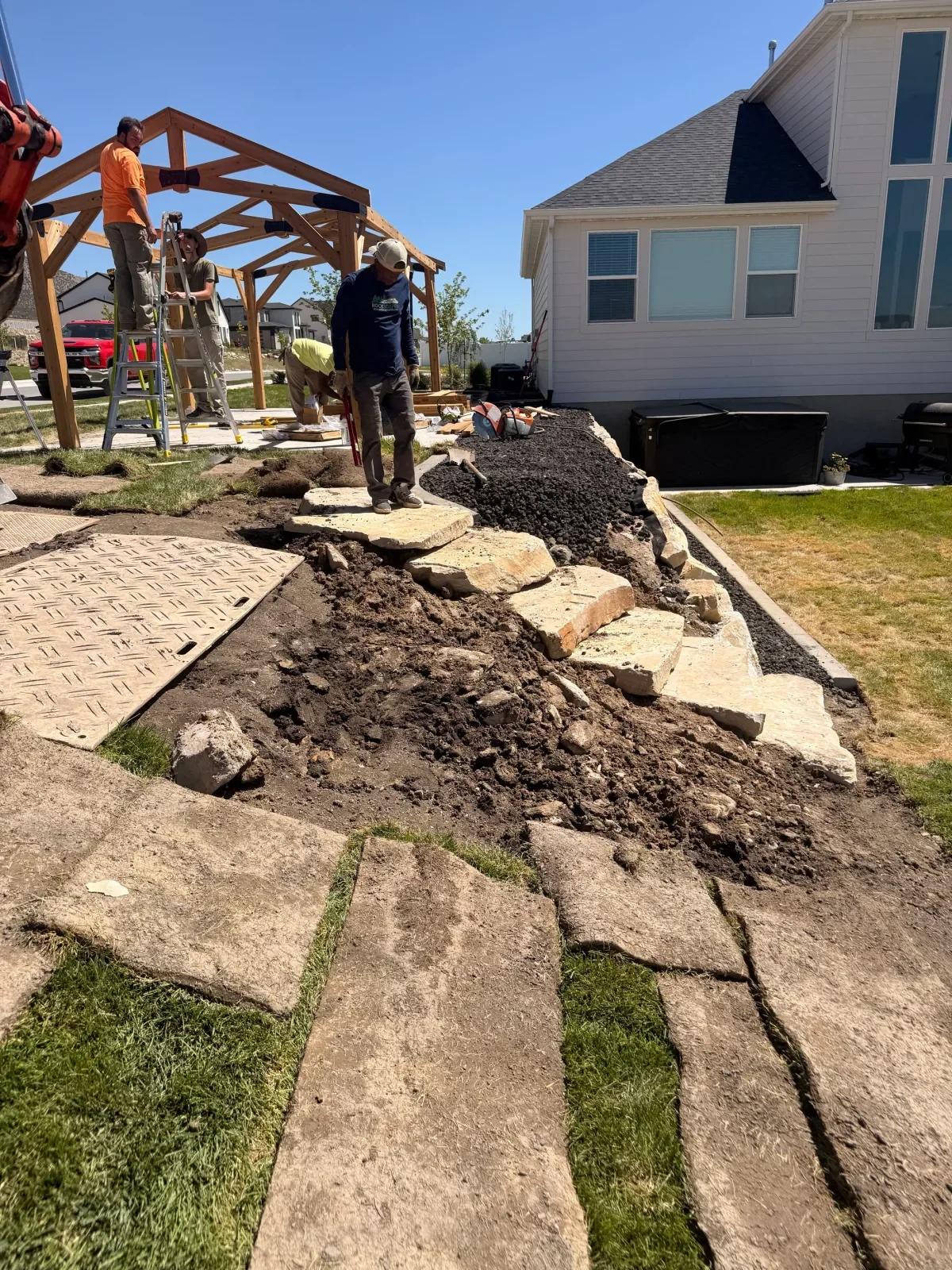 Monarch team installing landscape stone and a timber structure