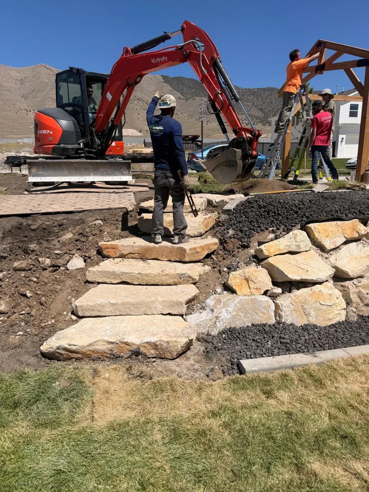 Monarch landscaping work in progress with stone steps and timber structure