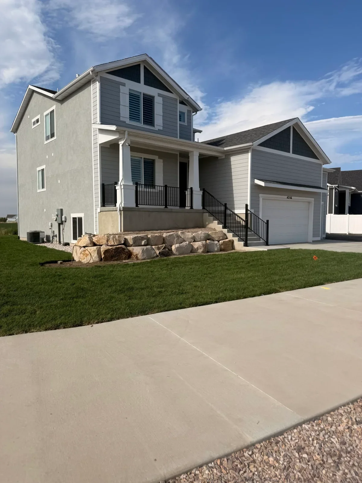 Finished client front lawn with natural-stone retaining wall