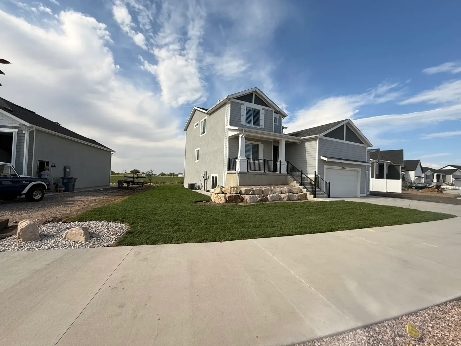 Completed client front-yard lawn and stone retaining wall